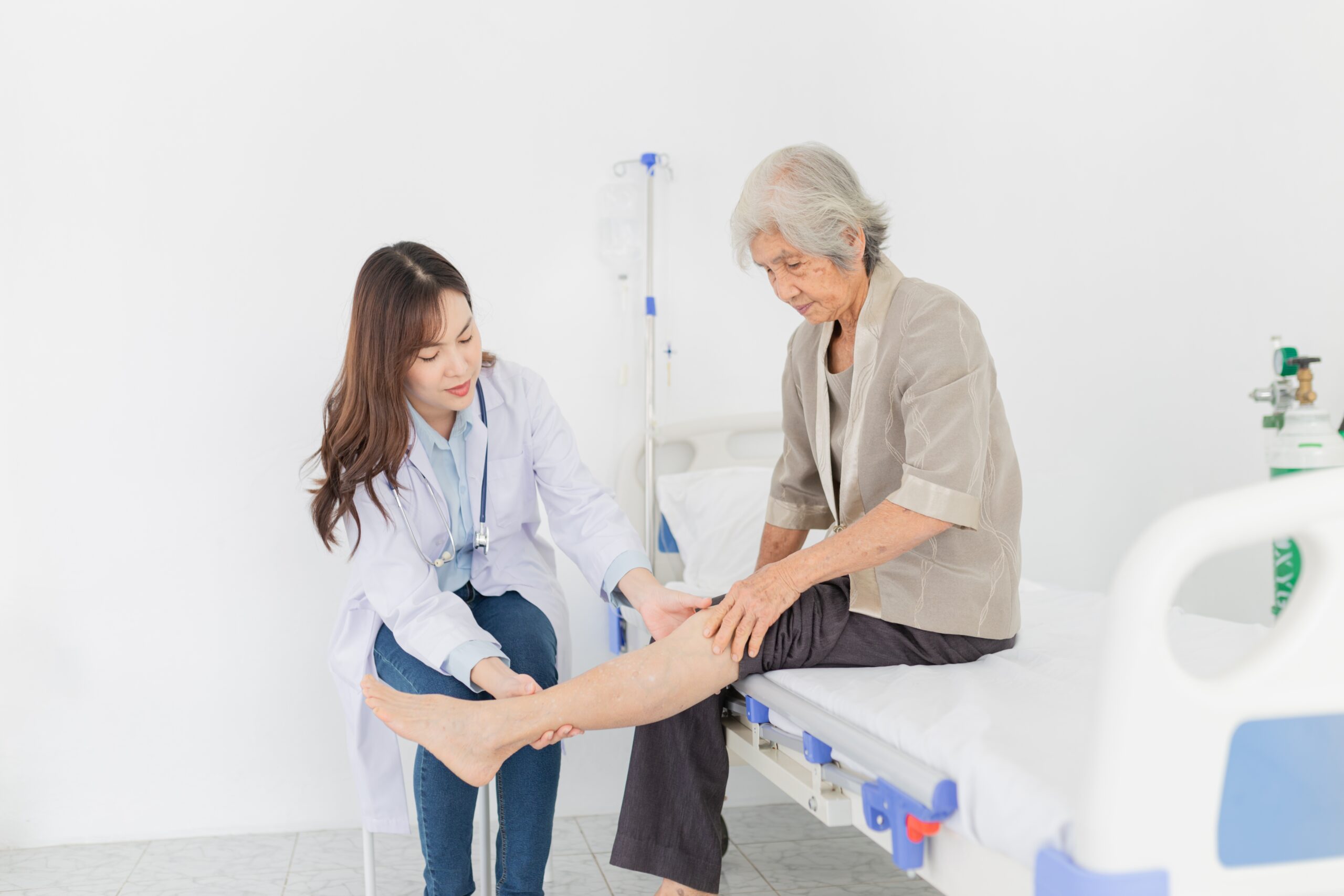 Female doctor treating elderly patient