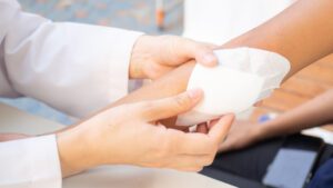 A doctor applying a bandage to an arm