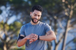 A man checking his fitness tracker while exercising