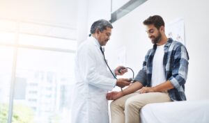 A doctor taking a man's blood pressure