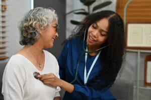 A doctor listening to a patient's heartbeat