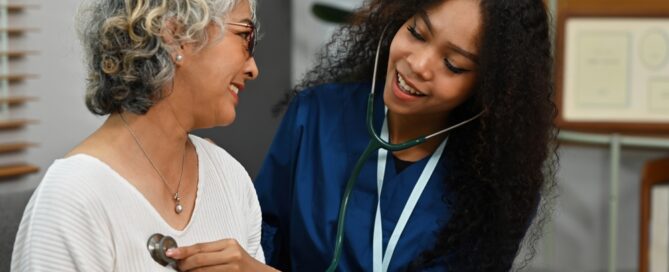 A doctor listening to a patient's heartbeat