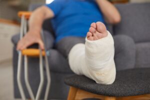 A man elevating a wrapped foot.